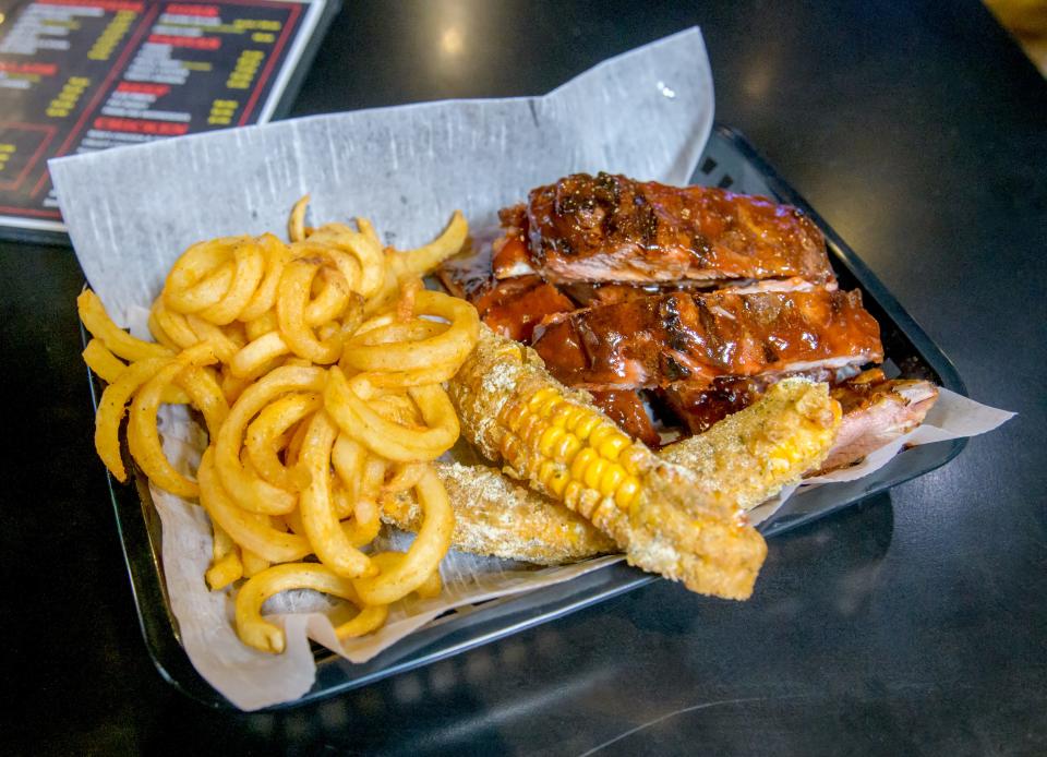 An order of ribs, corn ribs and curly fries await hungry customers at the new Highly Flavored restaurant at Landmark Recreation Center in Peoria.