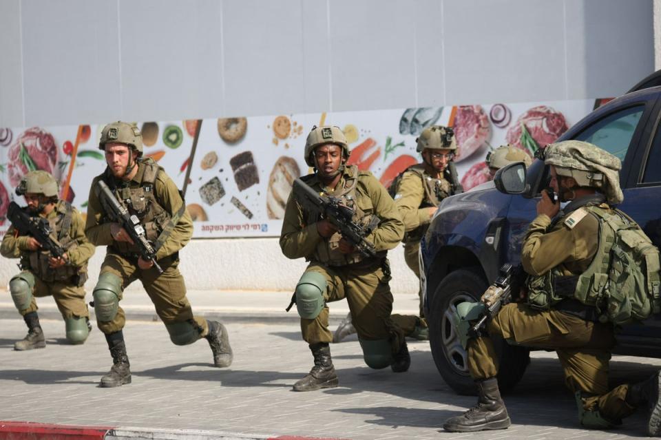 Israeli soldiers deploy in an area where civilians were killed in the southern city of Sderot on Saturday (AFP via Getty Images)