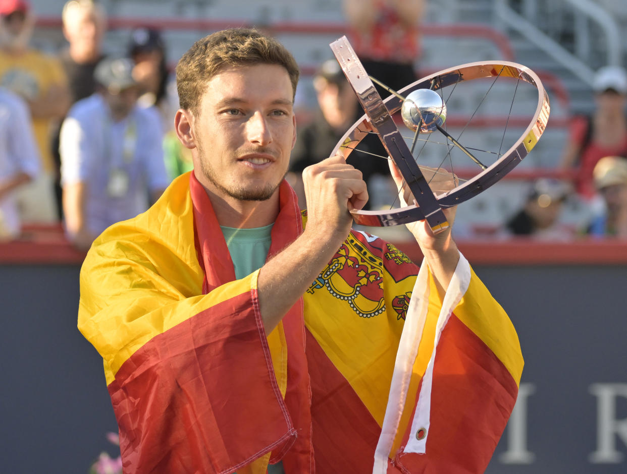 Aug 14, 2022; Montreal, QC, Canada; Pablo Carreno Busta (ESP) poses with the championship trophy after winning in the singles finals match during the National Bank Open at IGA Stadium. Mandatory Credit: Eric Bolte-USA TODAY Sports