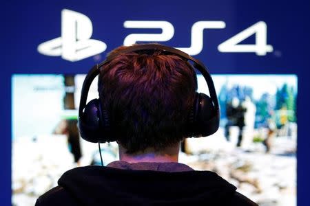 A visitors plays games on PlayStation 4 (PS4) at the Paris Games Week, a trade fair for video games in Paris, France, October 29, 2016. REUTERS/Charles Platiau