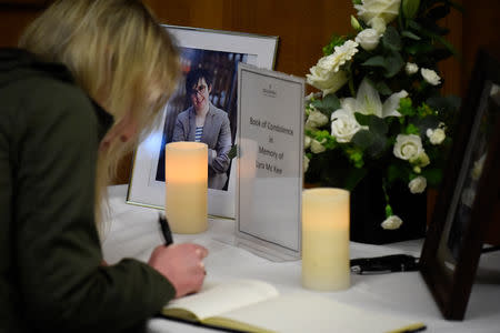 A woman signs a book of condolences in the Guildhall for the 29-year-old journalist Lyra McKee who was shot dead in Londonderry, Northern Ireland April 20, 2019. REUTERS/Clodagh Kilcoyne