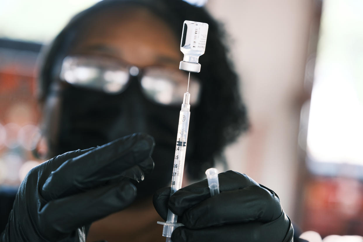 The Pfizer COVID-19 vaccine is prepared at a vaccine clinic on Wednesday in Ferguson, Mo.