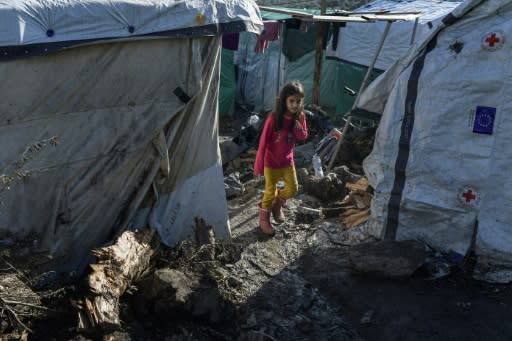 Children wander and play in the mud