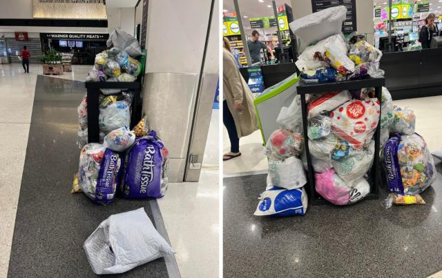 A photo of a bin overflowing with rubbish bags outside a Woolworths store at Warner, QLD. Source: Facebook/Sarah McDonald