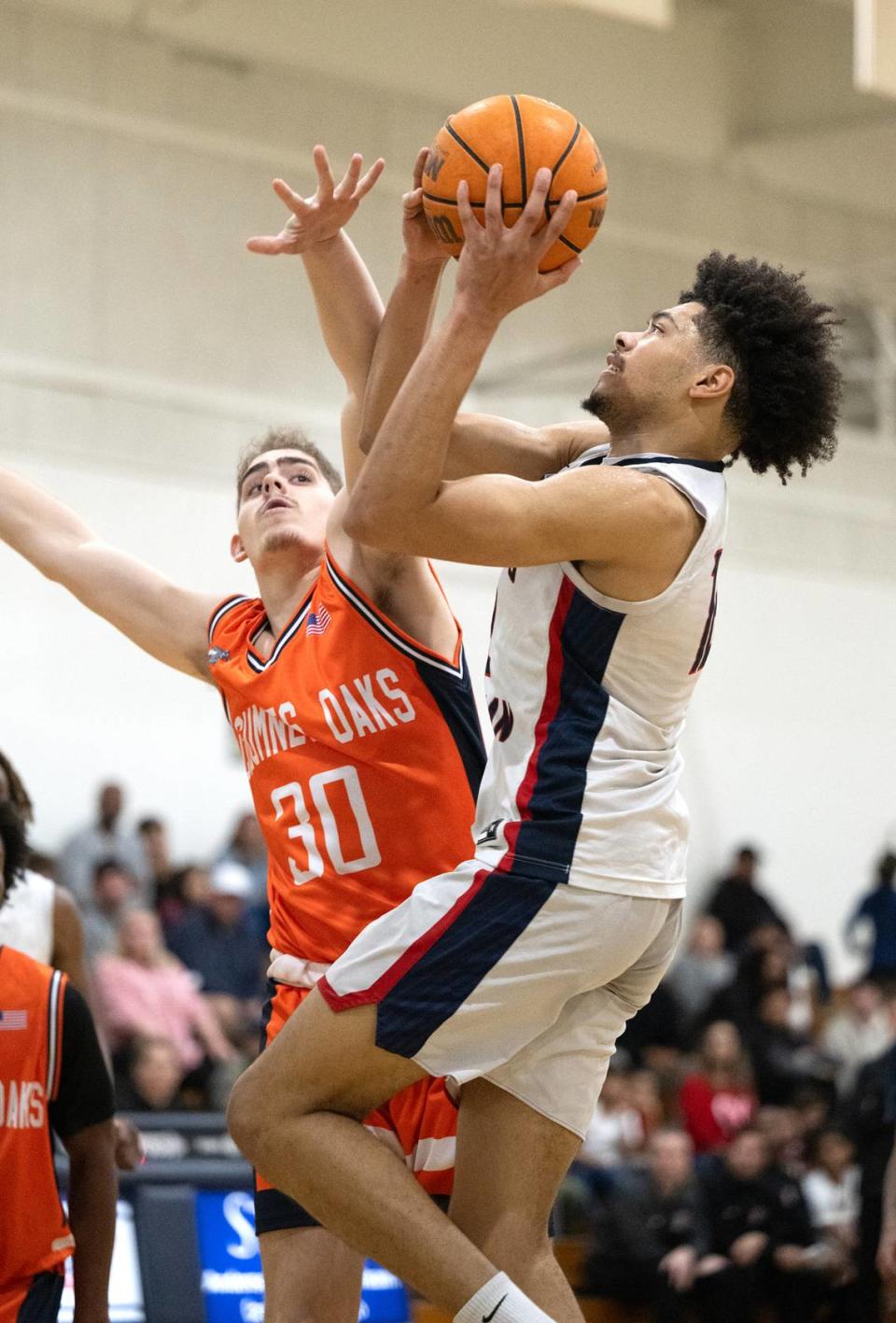 Modesto Christian’s Marcus Washington scores during the Sac-Joaquin Section Division I playoff game with Cosumnes Oaks at Modesto Christian High School in Salida, Calif., Wednesday, Feb. 14, 2024.