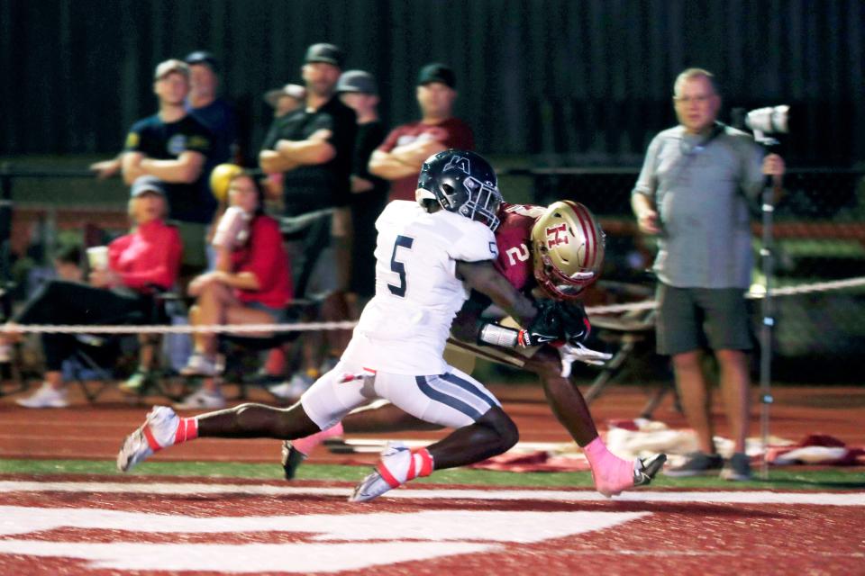 Hartfield Academy WR Bralan Womack (2) scores a touchdown as Jackson Academy DB A.J. Parker (5) tries to tackle Womack during a varsity high school game at Hartfield on Friday, Oct. 27, 2023, in Flowood, MS.