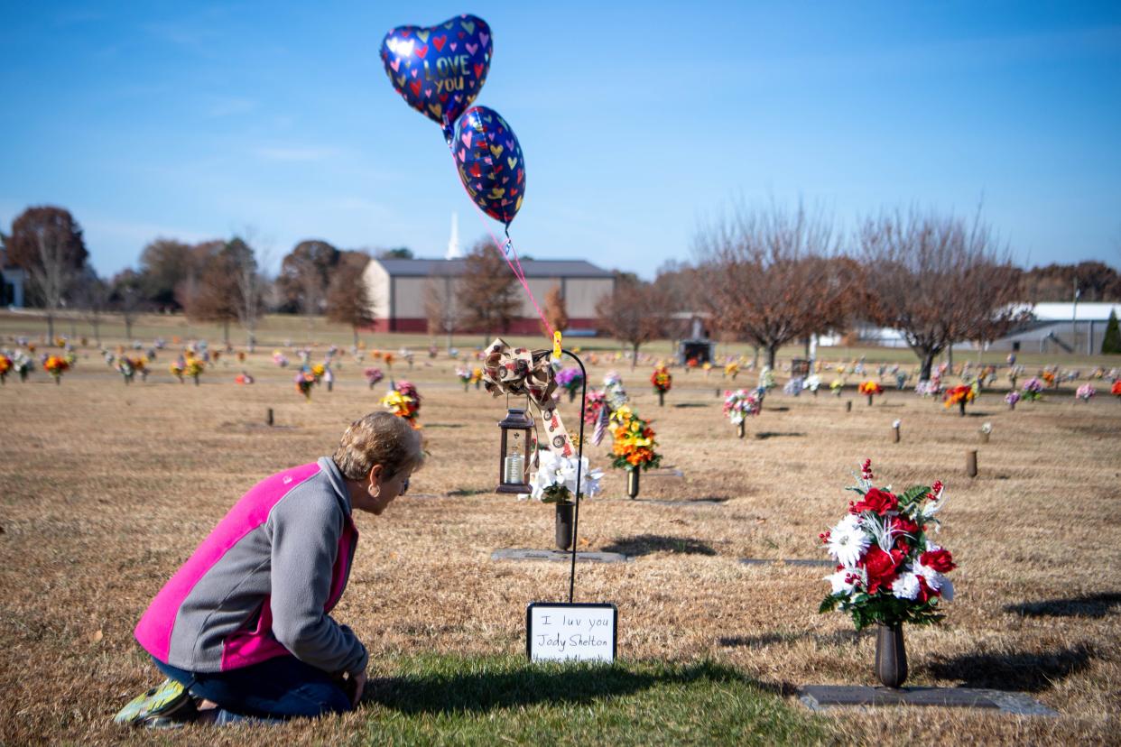 Kimberly Shelton kneels down and speaks to her husband, Joe Shelton Jr., at his grave Wednesday, Nov. 20, 2019, at Springfield Memorial Gardens.