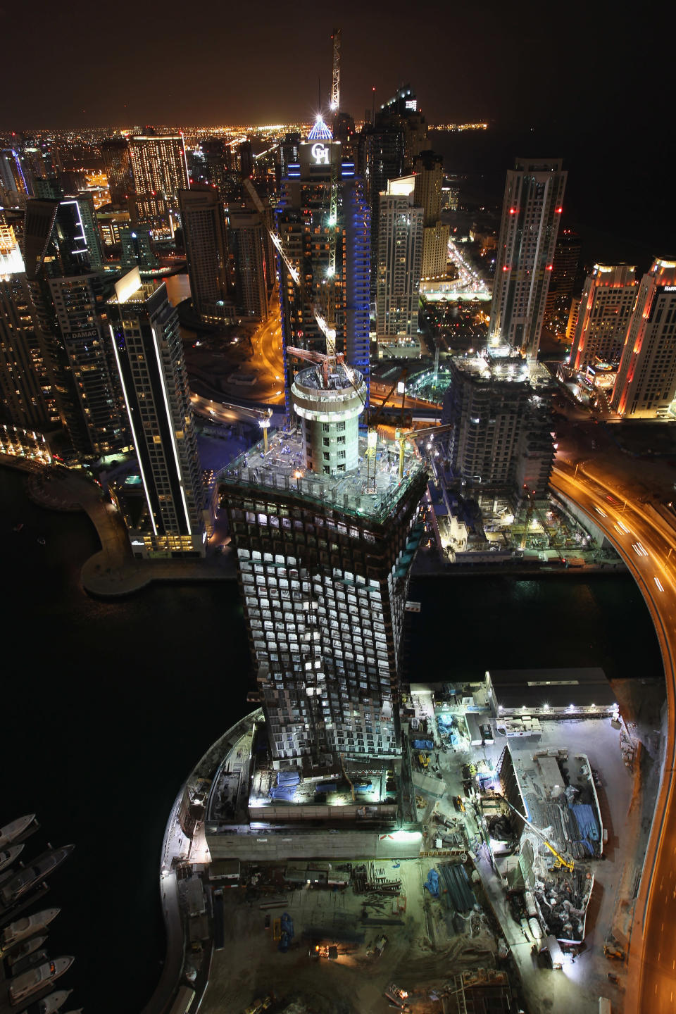 "All the high-rise buildings and apartments will be constructed on eco-friendly lines with water sports facilities on the river side," the official said. (A general view of the Dubai Marina at night, United Arab Emirates. Photo by David Rogers/Getty Images)