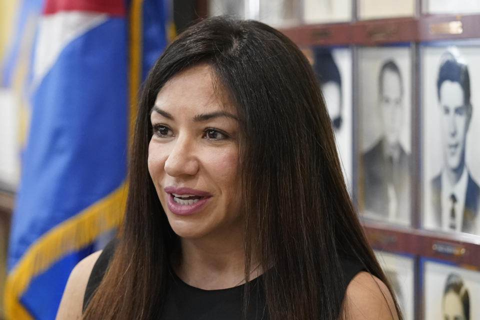 Business woman Irina Vilarino speaks after a news conference by mostly Cuban exiles, of their concern of the sale of two local Spanish language radio stations, Wednesday, June 8, 2022, at the Bay of Pigs Museum and Brigade 2506 headquarters in Miami's Little Havana neighborhood. Cuban exiles describe it as a clear attempt by Democrats to stifle conservative and anti-Communist voices in a Hispanic community where they've lost ground. "We would need to be deaf and blind not to understand the motives behind this buyout," said Vilarino, who co-owns a chain of Cuban restaurants in South Florida. (AP Photo/Wilfredo Lee)