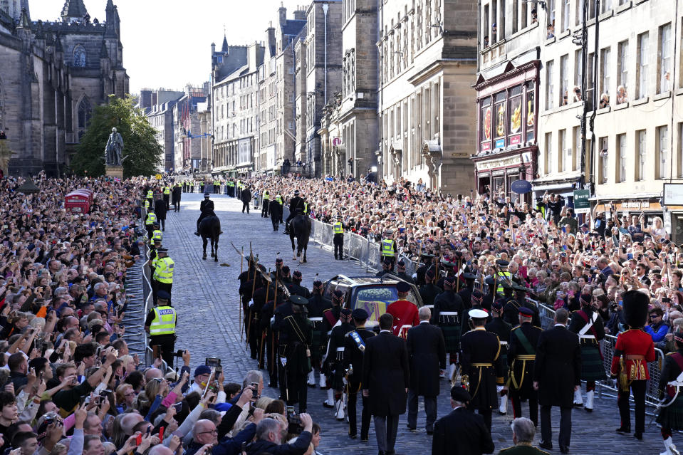 The Procession of Queen Elizabeth's coffin from the Palace of Holyroodhouse to St Giles Cathedral moves along the Royal Mile in Edinburgh, Scotland, Monday, Sept. 12, 2022. At the Cathedral there will be a Service to celebrate the life of The Queen and her connection to Scotland. (AP Photo/Jon Super, Pool)