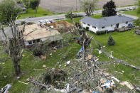 Debris from damaged homes litters the properties on Fairground Road after a tornado storm system passed through the area the previous night, Tuesday, May 28, 2019, in Celina, Ohio. A rapid-fire line of apparent tornadoes tore across Indiana and Ohio overnight, packed so closely together that one crossed the path carved by another. At least half a dozen communities from eastern Indiana through central Ohio suffered damage, according to the National Weather Service. (AP Photo/John Minchillo)