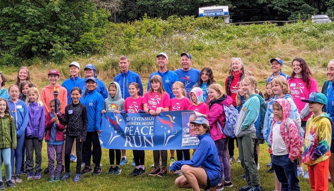 Members of Girls on the Run and Trail Blazers pose with Peace Run runners at Lake Padden in Bellingham on June 27, 2024.