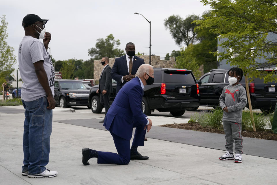 FILE - Democratic presidential candidate former Vice President Joe Biden visits with C.J. Brown, right, and Clement Brown, the son and father of the owner of Three Thirteen, as Biden arrives to shop for his grandchildren at the store in Detroit, Wednesday, Sept. 9, 2020. (AP Photo/Patrick Semansky, File)