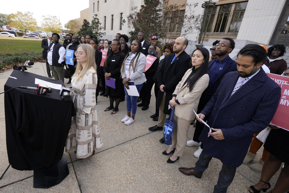 Brittany Denson, a poll monitor, left, recalls problems a number of Hinds County precincts encountered during the general election in November, at a news conference in Jackson, Miss., on Thursday, Dec. 7, 2023, (AP Photo/Rogelio V. Solis)