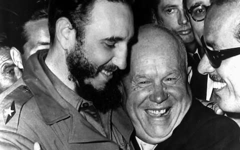 Cuban president Fidel Castro, left, and Soviet leader Nikita Khrushchev hug at the United Nations in this late 1960 file photo - Credit: AP