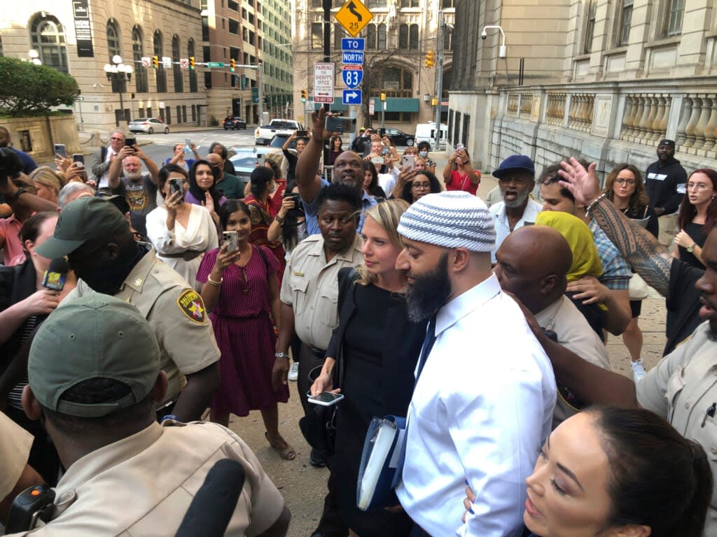 Adnan Syed, center, leaves the Cummings Courthouse on Sept. 19, 2022, in Baltimore. A judge has ordered the release of Syed on Tuesday, Oct. 11 after overturning his conviction for a 1999 murder that was chronicled in the hit podcast “Serial.” (AP Photo/Brian Witte, File)