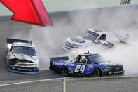 Chase Elliott (24) and Brett Moffitt (23) spin out during a NASCAR Truck Series auto race Saturday, June 13, 2020, in Homestead, Fla. (AP Photo/Wilfredo Lee)