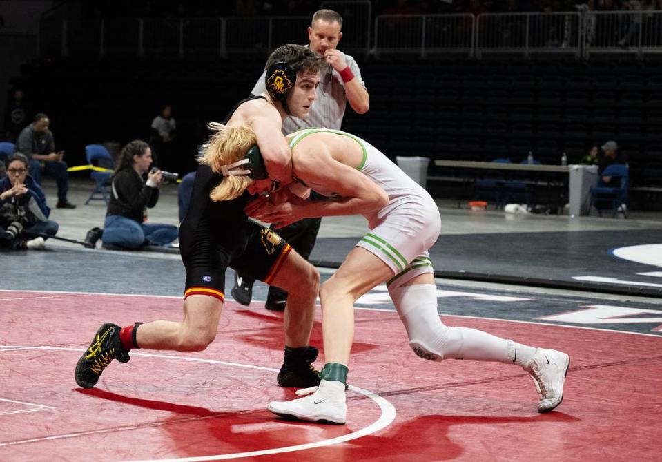 Oakdale’s Eziequel Vela wraps up Kyle Holtberg of St. Mary’s in the 126-pound title match during the Sac-Joaquin Section Masters Wrestling Championships at Stockton Arena in Stockton, Calif., Saturday, Feb. 17, 2024. Vela won by fall at 1:29.