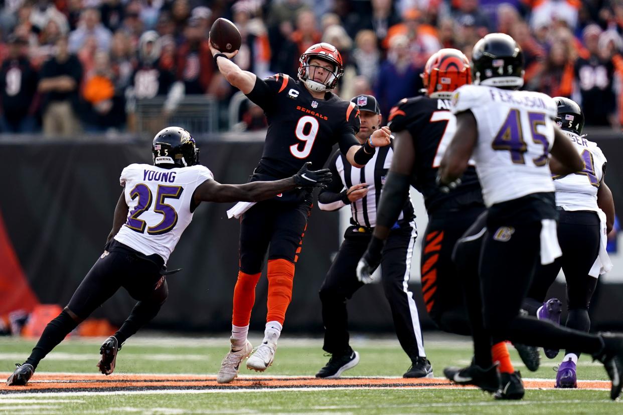 Cincinnati Bengals quarterback Joe Burrow (9) throws under pressure in the first quarter during a Week 16 NFL game against the Baltimore Ravens, Sunday, Dec. 26, 2021, at Paul Brown Stadium in Cincinnati.