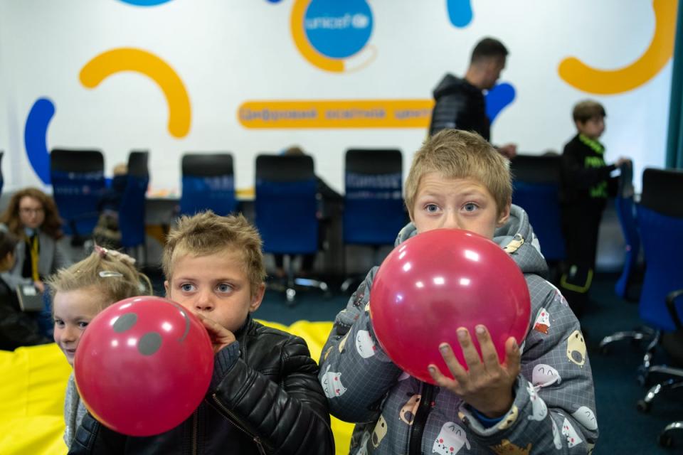 Iaroslav and his older brother Sasha blow up balloons in the children’s playroom of the Kharkiv transit centre (Unicef)