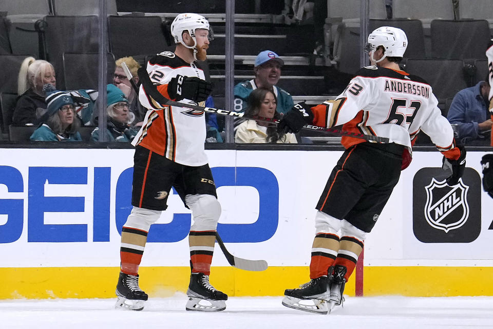 Anaheim Ducks' Hunter Drew, left, is congratulated by Axel Andersson (63) after scoring a goal against the San Jose Sharks during the first period of a preseason NHL hockey game in San Jose, Calif., Tuesday, Sept. 27, 2022. (AP Photo/Tony Avelar)