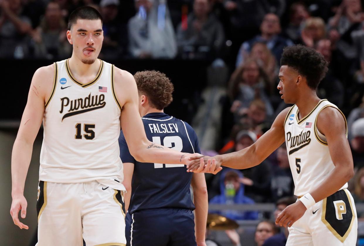 Purdue Boilermakers center Zach Edey (15) high-fives Purdue Boilermakers guard Myles Colvin (5) during NCAA Men’s Basketball Tournament game against the Utah State Aggies, Sunday, March 24, 2024, at Gainbridge Fieldhouse in Indianapolis.