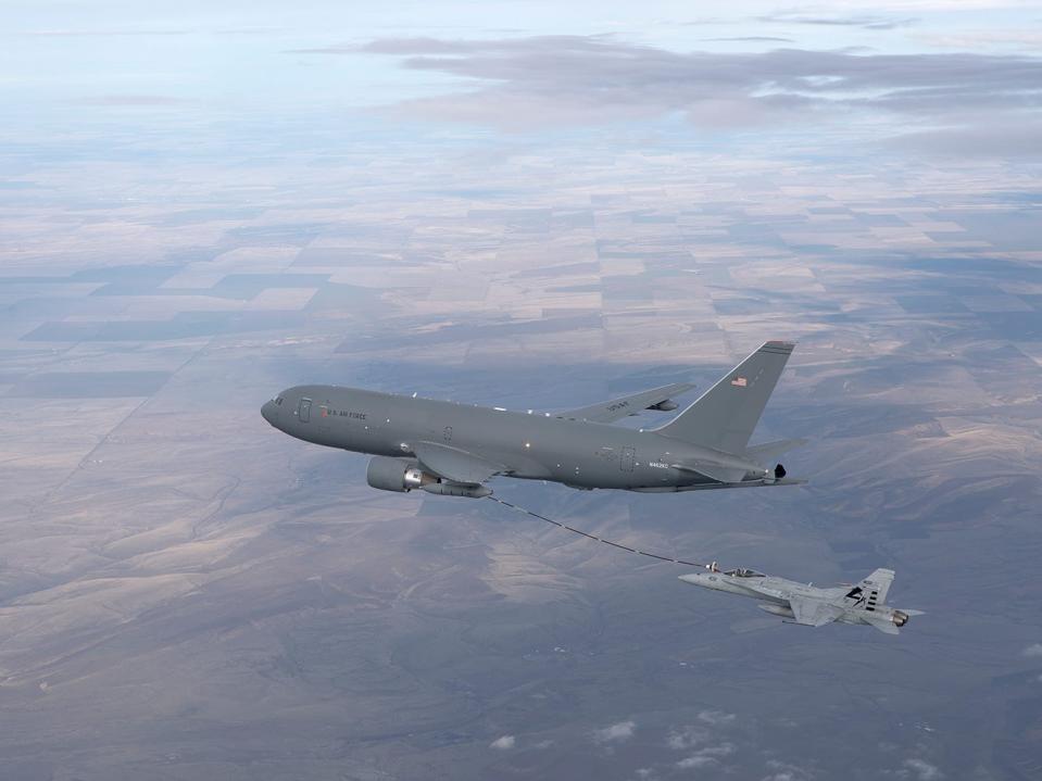 A KC-46 refueling via hose-and-drogue midair.