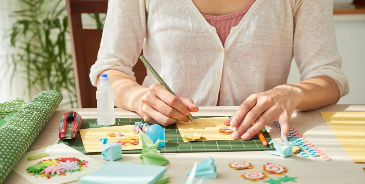 woman doing simple craft at wooden table