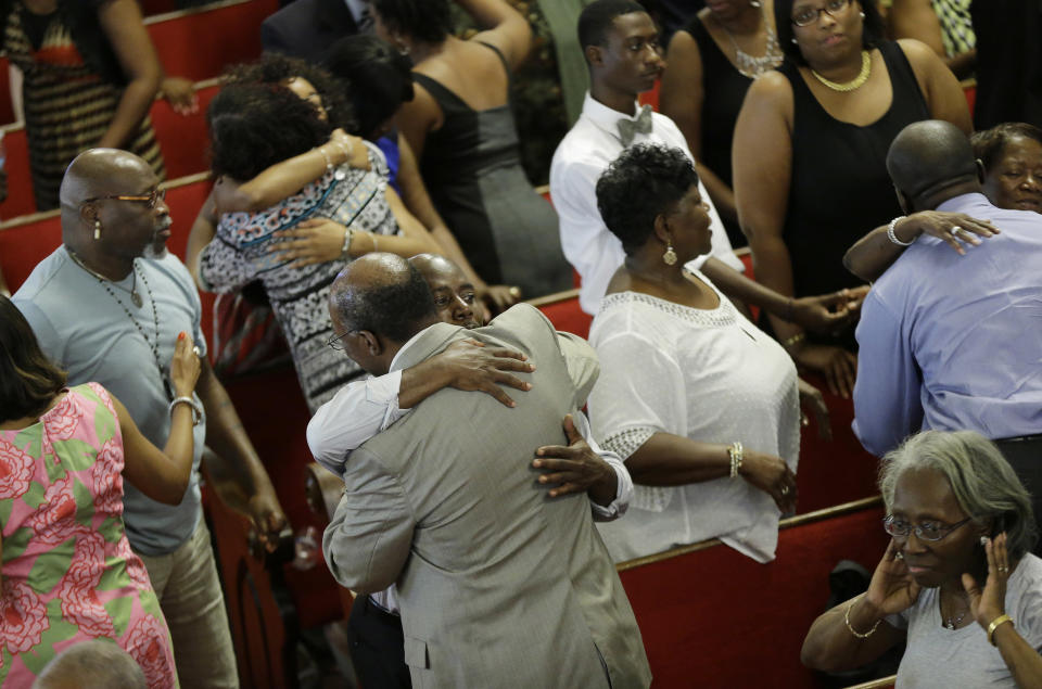 Parishioners embrace at the Emanuel A.M.E. Church Sunday, June 21, 2015, in Charleston, S.C., four days after a mass shooting that claimed the lives of it's pastor and eight others. (AP Photo/David Goldman, Pool)