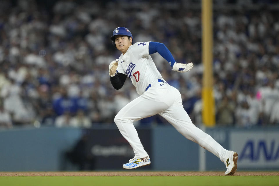 Los Angeles Dodgers' Shohei Ohtani runs from second to third base during the fourth inning in Game 1 of baseball's NL Division Series against the San Diego Padres, Saturday, Oct. 5, 2024, in Los Angeles. (AP Photo/Mark J. Terrill)