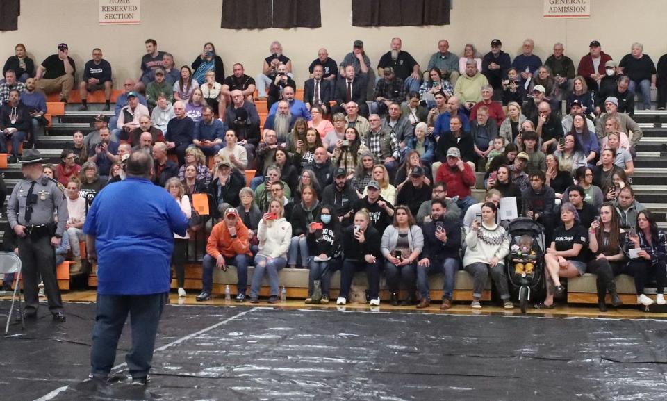 East Palestine Mayor Trent Conaway  addresses the audience gathered at a meeting at East Palestine High School on Wednesday.