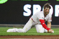 Philadelphia Phillies right fielder Bryce Harper reaches for the ball on an RBI double by Boston Red Sox's Rafael Devers during the third inning of a baseball game, Saturday, May 22, 2021, in Philadelphia. (AP Photo/Chris Szagola)