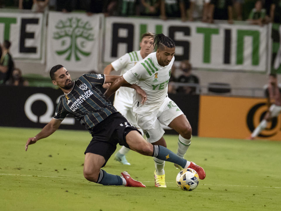 LA Galaxy forward Samuel Grandsir, left, tries to control the ball against Austin FC midfielder Cecilio Domínguez during the first half of an MLS soccer match, Sunday, Sept. 26, 2021, in Austin, Texas. (AP Photo/Michael Thomas)