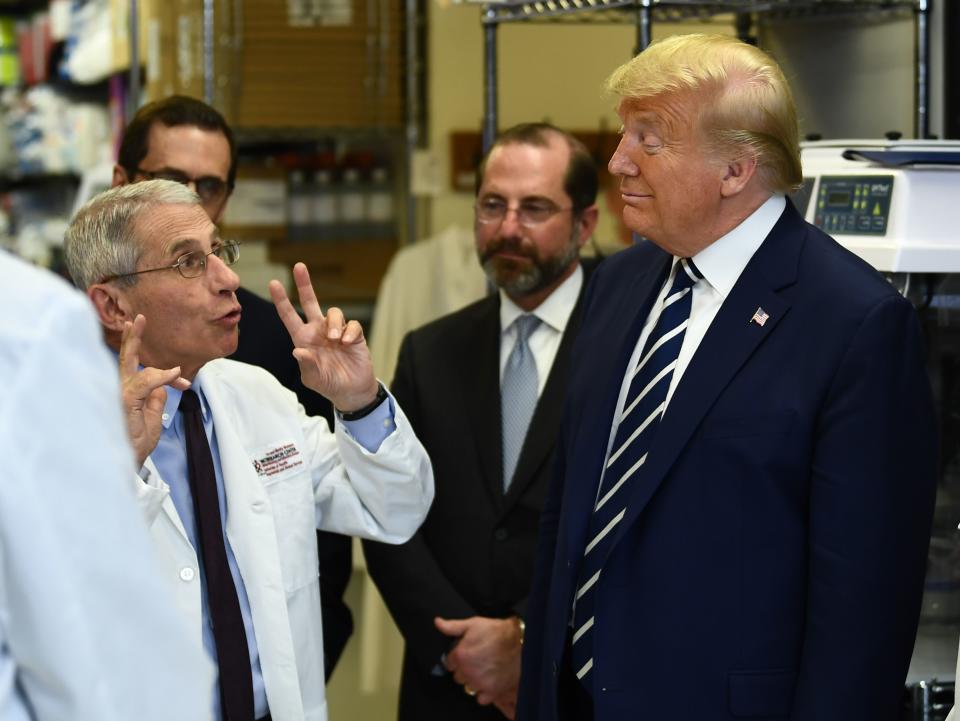 National Institute of Allergy and Infectious Diseases Director Tony Fauci speaks to US President Donald Trump during a tour of the National Institutes of Health's Vaccine Research Center March 3, 2020, in Bethesda, Maryland. - The US Federal Reserve announced an emergency rate cut responding to the growing economic risk posed by the coronavirus epidemic after the UN health agency said the world has entered "uncharted territory" with the outbreak's rapid spread. (Photo by Brendan Smialowski / AFP) (Photo by BRENDAN SMIALOWSKI/AFP via Getty Images)