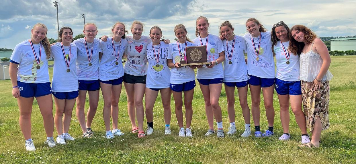 Members of the Kennebunk High School girls tennis team display their Class A state championship plaque after Saturday's 5-0 win over Brunswick at South Portland High School.