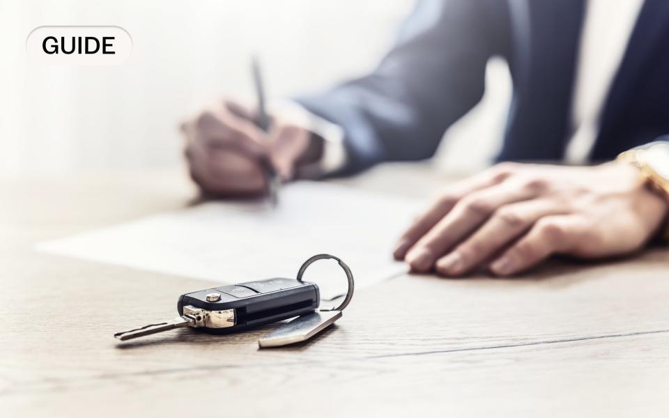 man signing a car insurance contract