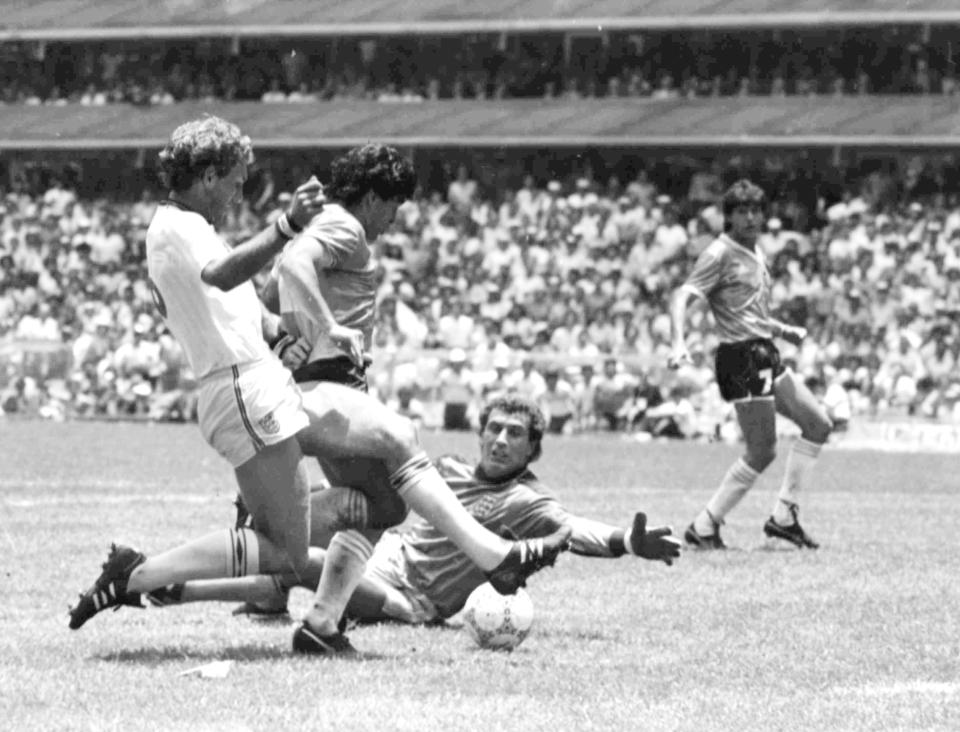 FILE - Argentina's Diego Maradona, second left, is about to score his second goal against England, during their World Cup quarter final soccer match, in Mexico City, Mexico on June 22, 1986. England's Terry Butcher, left, tries to tackle Maradona, while England's goalkeeper Peter Shilton is on the ground. Argentina won the match 2-1. (AP Photo/File)