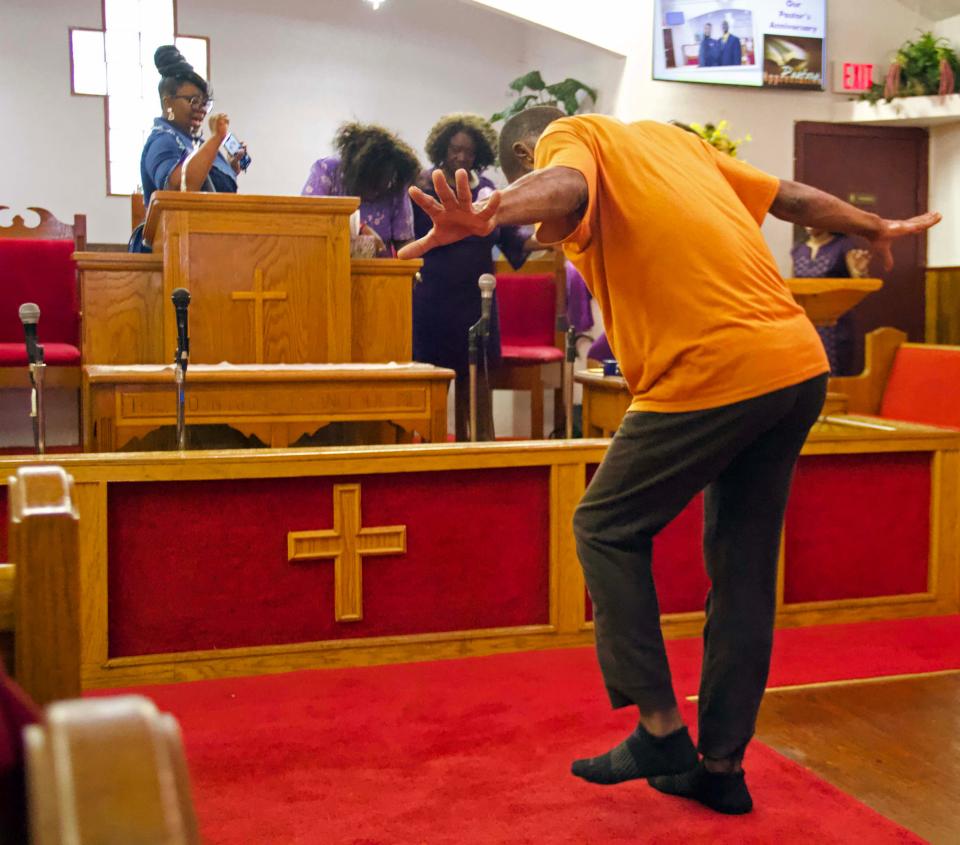 Parishioners are overcome with an abundance of joy and begin to dance and run throughout Pilgrim Rest Church of God In Unity in northeast Gainesville on Sunday.