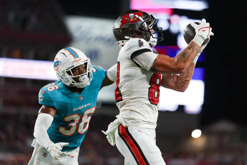 Aug 23, 2024; Tampa, Florida, USA; Tampa Bay Buccaneers wide receiver Ryan Miller (81) receives a pass for a touchdown defended by Miami Dolphins cornerback Storm Duck (36) in the second quarter during preseason at Raymond James Stadium. Mandatory Credit: Nathan Ray Seebeck-USA TODAY Sports