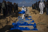 Palestinians bury the bodies of people who were killed in fighting with Israel and returned to Gaza by the Israeli military, during a mass funeral in Rafah, Gaza Strip, Tuesday, Jan. 30, 2024. (AP Photo/Fatima Shbair)