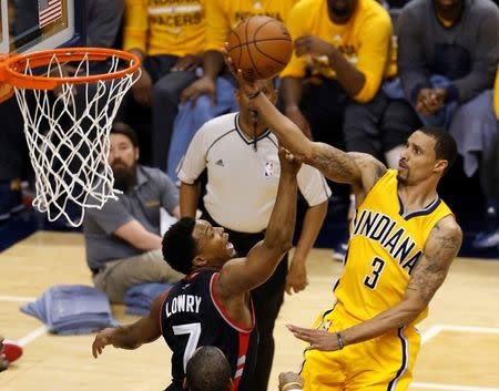 Apr 21, 2016; Indianapolis, IN, USA; Indiana Pacers guard George Hill (30 takes a shot against Toronto Raptors guard Kyle Lowry (7) in the first quarter in game three of the first round of the 2016 NBA Playoffs at Bankers Life Fieldhouse. Brian Spurlock-USA TODAY Sports