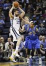 Memphis Grizzlies center Marc Gasol (33), of Spain, goes to the basket against Dallas Mavericks guard Monta Ellis (11) and forward Dirk Nowitzki, of Germany, during the first half of an NBA basketball game Wednesday, April 16, 2014, in Memphis, Tenn. (AP Photo/Lance Murphey)