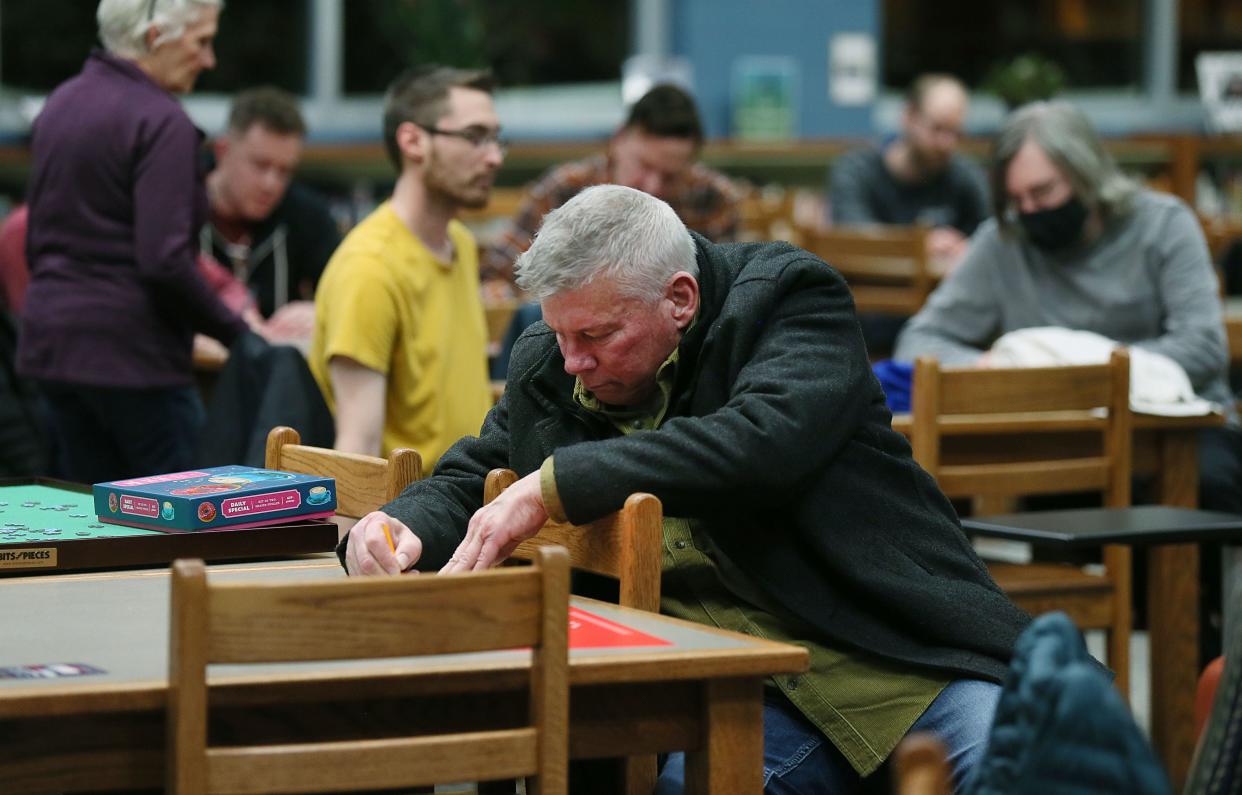 GOP caucusgoers write their favorite candidates' names on ballot paper during Iowa Caucuses at Ames Middle School on Monday.