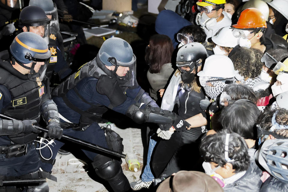 Police arrest protesters with their face covered. (Etienne Laurent / AFP - Getty Images)