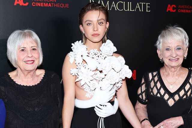 <p>Amy Sussman/Getty</p> Sydney Sweeney with her grandmothers at the premiere of 'Immaculate'