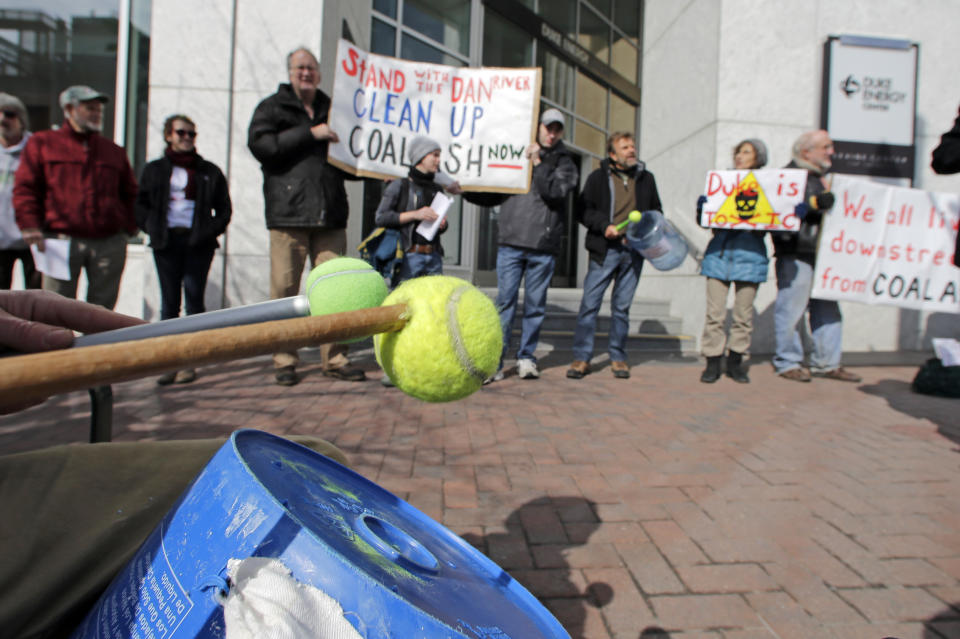 A drummer keeps a beat as demonstrators chant during a protest near Duke Energy's headquarters in Charlotte, N.C., Thursday, Feb. 6, 2014 over Duke Energy's coal plants. Duke Energy estimates that up to 82,000 tons of ash has been released from a break in a 48-inch storm water pipe at the Dan River Power Plant on Sunday. (AP Photo/Chuck Burton)