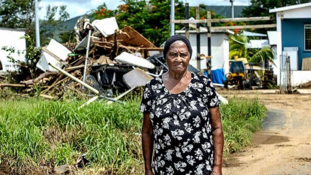 PHOTO: Brunilda Colaan, 79, an iconic figure in her neighborhood, stands amid hurricane damage near her house in Salinas, Puerto Rico, Sept. 23, 2022. (El Nuevo Herald/Tribune News Service via Getty Images)