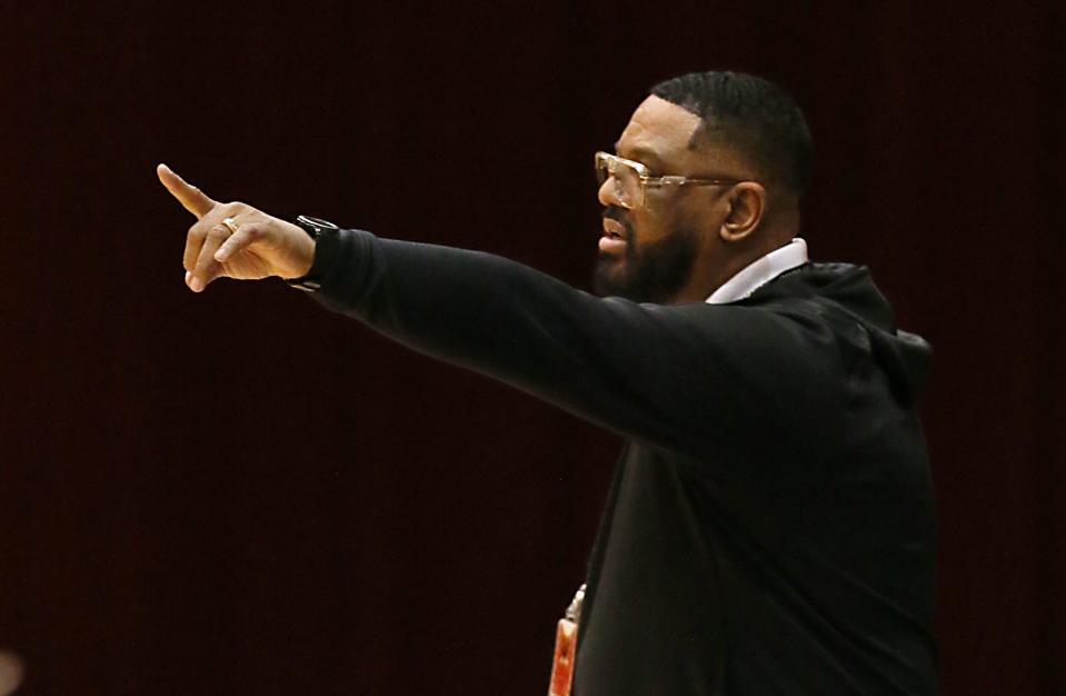 Buchtel coach Rayshon Dent directs his team during a Division II regional semifinal March 9 in Canton.