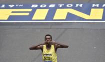 Lelisa Desisa, of Ethiopia, kisses his hands after crossing the finish line to win the men's division of the 119th Boston Marathon in Boston, Massachusetts April 20, 2015. REUTERS/Gretchen Ertl