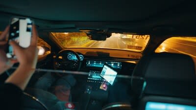 An Apollo Go user on a nighttime ride in a fully driverless vehicle